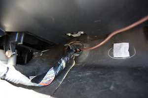 Cable running from the interior of the vehicle, through the firewall to the engine compartment