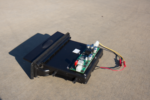 The DC-DC converter, used to regulate the vehicle's battery voltage and power the system