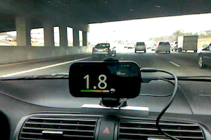 The Android mobile phone, showing a time headway of 1.8 seconds, rainy conditions and a lead vehicle velocity of 38 mph